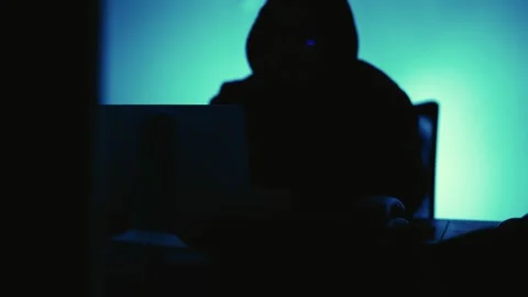 A computer programmer or hacker prints a code on a laptop keyboard to break i Stock Footage 138949353