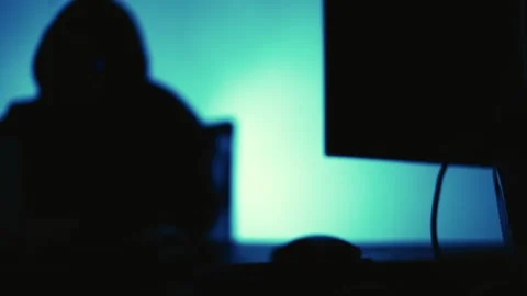A computer programmer or hacker prints a code on a laptop keyboard to break i Stock Footage 138949377
