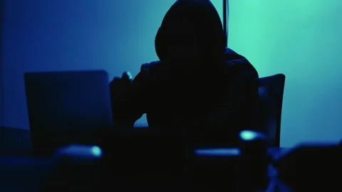 A computer programmer or hacker prints a code on a laptop keyboard to break i Stock Footage 138949383