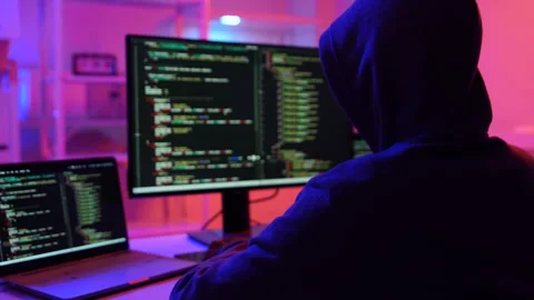 A computer programmer or hacker prints a code on a laptop keyboard to break into Video stock 325556617