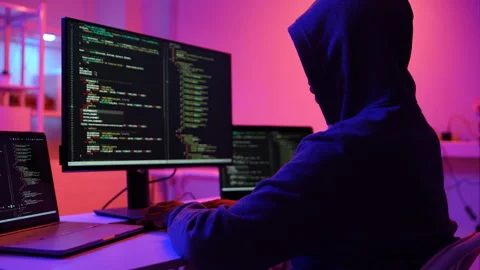 A computer programmer or hacker prints a code on a laptop keyboard to break into Stock Footage 325556826