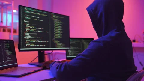 A computer programmer or hacker prints a code on a laptop keyboard to break into Video stock 327387784