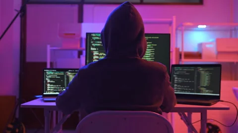 A computer programmer or hacker prints a code on a laptop keyboard to break into Stock Footage 327387966