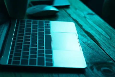 A computer programmer or hacker prints a code on a laptop keyboard to break i 写真素材