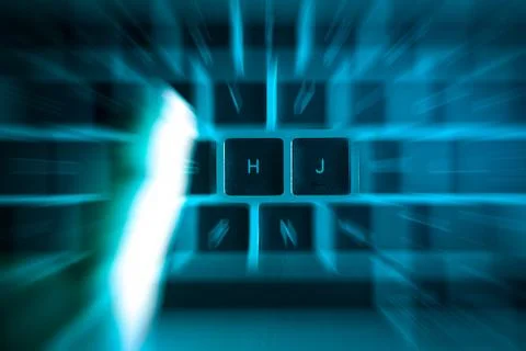 A computer programmer or hacker prints a code on a laptop keyboard to break i Foto stock