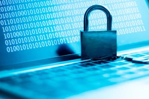 A computer programmer or hacker prints a code on a laptop keyboard to break i Stockfoto's