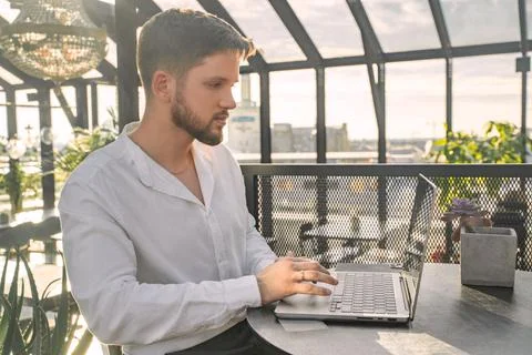 Computer programmer typing on laptop working in cosy office Stock-Fotos
