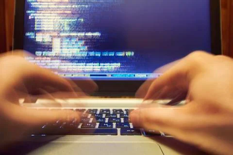 Computer programmer typing long code 库存照片