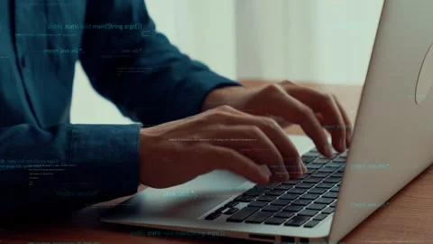 Computer programmer uses capable laptop computer to develop programming code Stock Footage 170556336