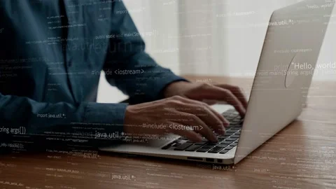 Computer programmer uses capable laptop computer to develop programming code Stock Footage 171359392
