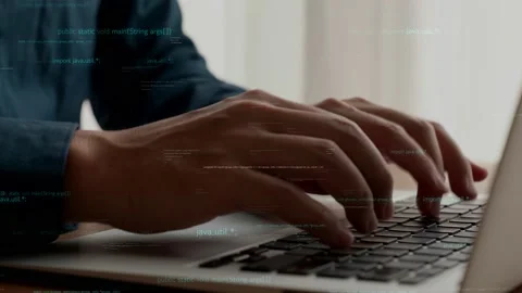 Computer programmer uses capable laptop computer to develop programming code Stock Footage 184282797