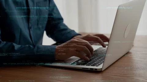Computer programmer uses capable laptop computer to develop programming code Stock Photos