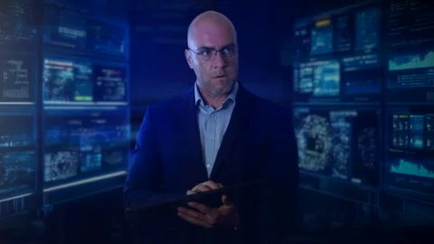 An computer programmer using a keyboard, standing in front of multiple Stock Footage 284958307