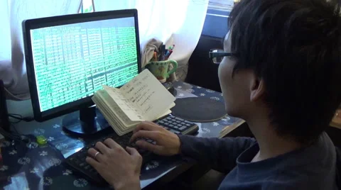 Computer programmer watching the running program log and notebook Stock Footage 42798527