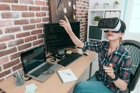 Computer programmer wearing VR technology goggles 写真素材