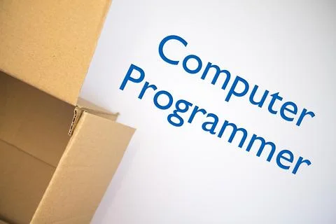 Computer Programmer word with cardboard box. Brown folded card box. Stock Photos