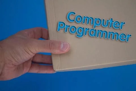 Computer Programmer word with cardboard box. Brown folded card box. Stock-Fotos
