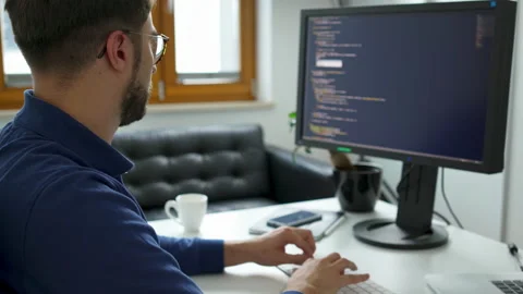 Computer programmer working on computer writing code Stock Footage 162468471