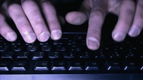 Computer programmer working at night typing code indoor, fingers and keyboard Stock Footage 203565137