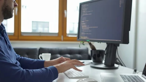 Computer programmer writing code working from home office Stock Footage 162468769