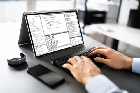 Computer Programmer Writing Program Code On Computer Foto stock