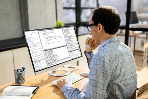 Computer Programmer Writing Program Code On Computer Foto stock