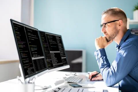 Computer Programmer Writing Program Code On Computer Stock Photos
