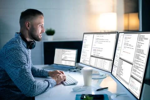 Computer Programmer Writing Program Code On Computer Foto stock