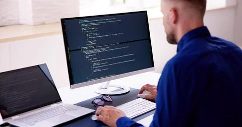 Computer Programmer Writing Program Code On Computer In Office 스톡 사진