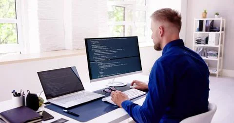 Computer Programmer Writing Program Code On Computer 写真素材