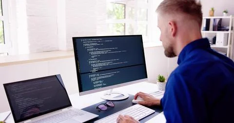 Computer Programmer Writing Program Code On Computer Stock Photos