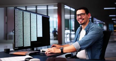 Computer Programmer Writing Program Code On Computer In Office Foto stock