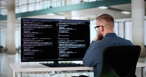 Computer Programmer Writing Program Code On Computer 库存照片