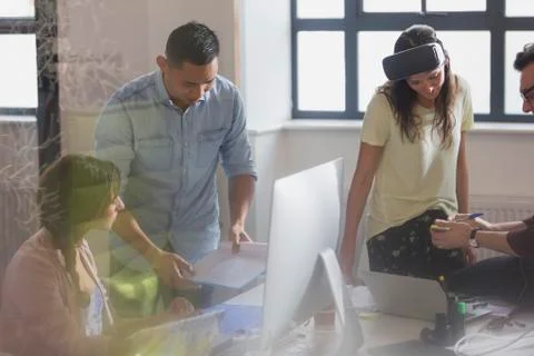 Computer programmers programming virtual reality simulator glasses in office Stock Photos