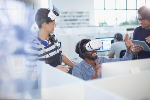 Computer programmers testing virtual reality simulators in office Stock-Fotos