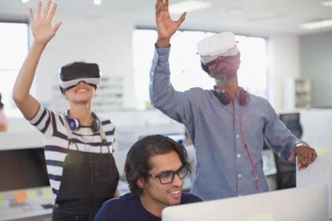 Computer programmers testing virtual reality simulators in office Stock-Fotos