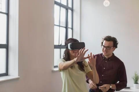 Computer programmers testing virtual reality simulator glasses in office Stock-Fotos