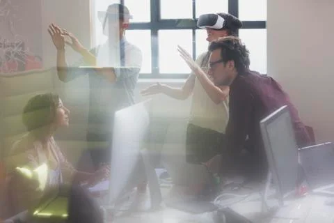 Computer programmers testing virtual reality simulator glasses in office Stock-Fotos