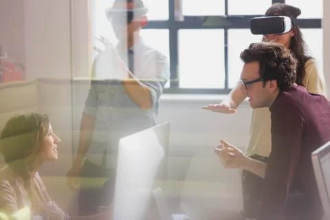 Computer programmers testing virtual reality simulator glasses in office Stock-Fotos
