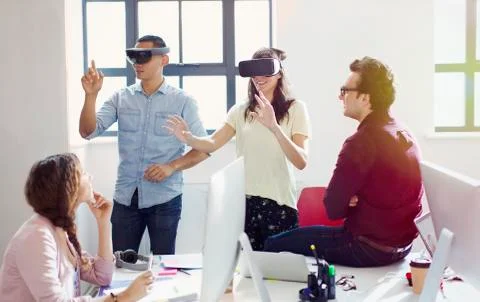 Computer programmers testing virtual reality simulator glasses in office Stock-Fotos