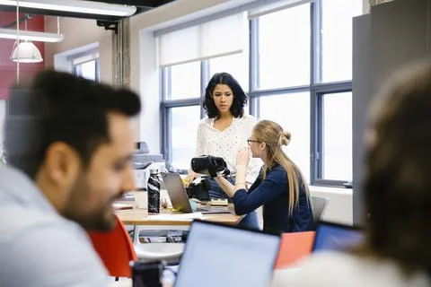 Computer programmers with virtual reality simulator glasses in office Stock-Fotos