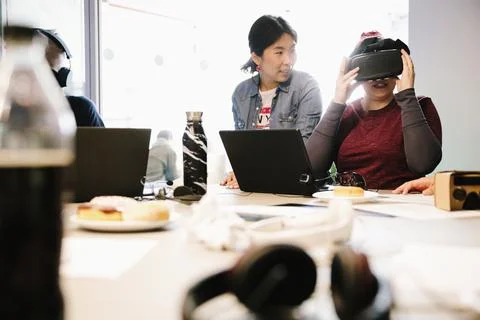 Computer programmers with virtual reality simulators working in office Stock-Fotos
