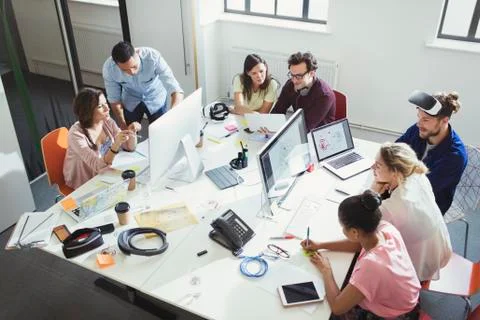 Computer programmers working in open plan office Stock-Fotos