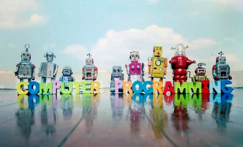 COMPUTER PROGRAMMING wooden letters and retro robot toys Stock-Fotos