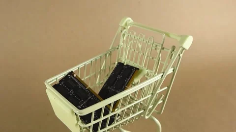 Computer RAM memory modules inside a miniature shopping cart Stock Footage 346594449