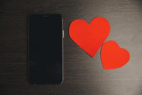 Computer with red hearts on table close up Stock Photos