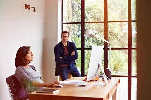 Computer, remote work and research with couple in home office together for .. Stock Photos