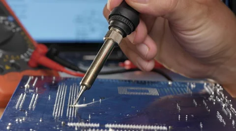 Computer repair concept.  Soldering Iron and motherboard Vidéo 68368808