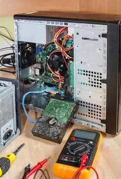 Computer repair. Open tower PC upgrading hard drive UK Stock Photos