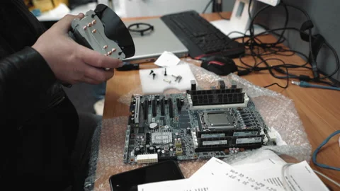 Computer repair service technician assembles a new motherboard to computer from Stock Footage 134332389